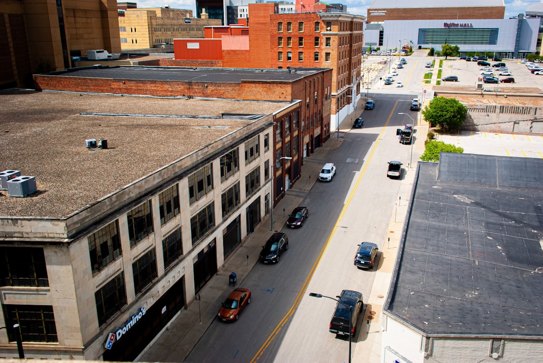 a city street filled with lots of traffic next to tall buildings